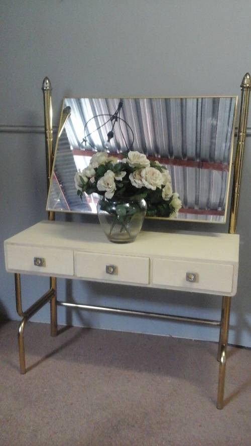 WOW A MAGNIFICENT POSSIBLY BRASS AND WOOD DRESSING TABLE. HAS A MIRROR AND THREE DRAWERS