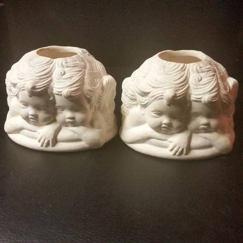 TWO UNPAINTED CERAMIC ITEM WITH FOUR ANGELS AROUND EACH ITEM