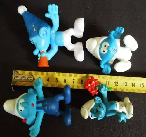 four collectible smurf figures