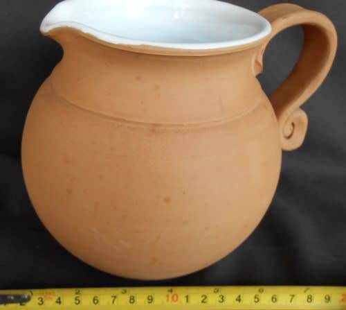 Beautiful classic shape terracotta jug with white glaze inside from Italy