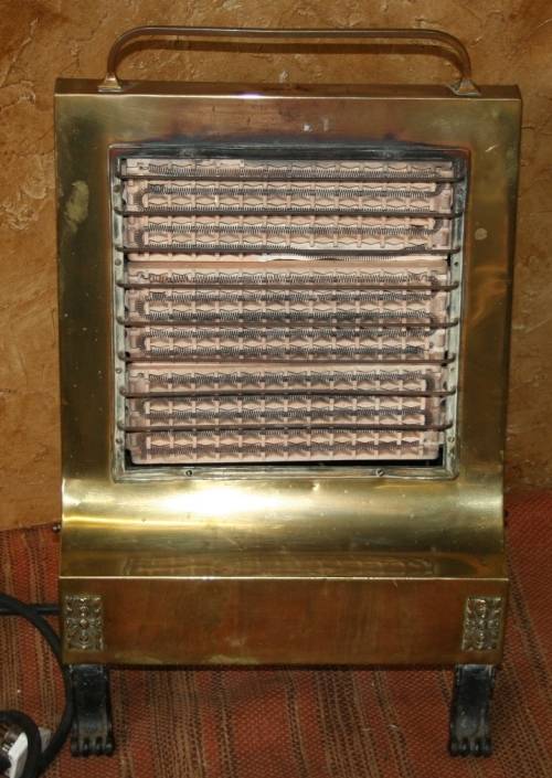 Wow a Vintage electric heater Made of brass and cast iron  Front and sides are brass Cast Iron legs