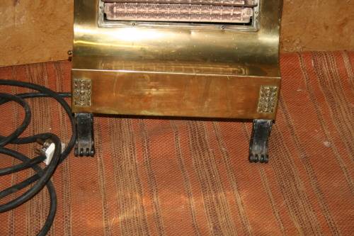 Wow a Vintage electric heater Made of brass and cast iron  Front and sides are brass Cast Iron legs