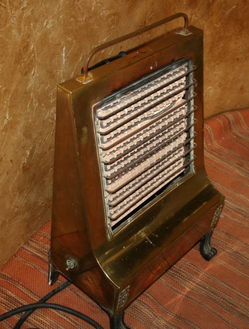 Wow a Vintage electric heater Made of brass and cast iron  Front and sides are brass Cast Iron legs