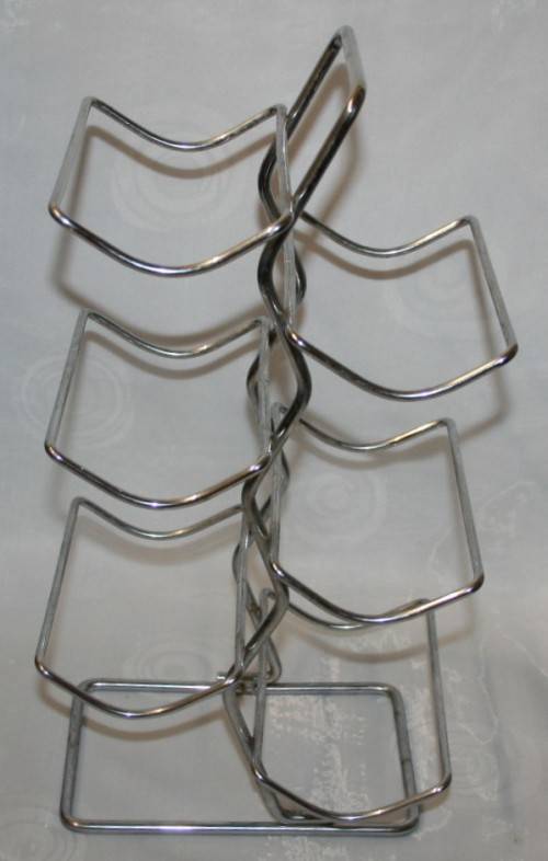 Here is a great, vintage, 5 bottle wine rack made out of Stainless steel. Stunning