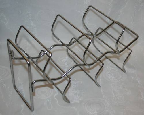 Here is a great, vintage, 5 bottle wine rack made out of Stainless steel. Stunning