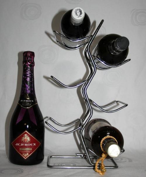 Here is a great, vintage, 5 bottle wine rack made out of Stainless steel. Stunning