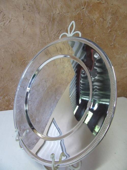This timeless silver metal under plates will find itself on some of the best tables around.