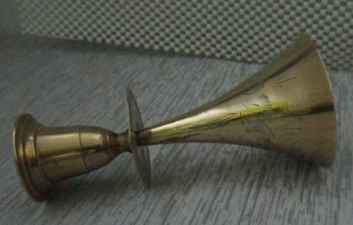 A MARVELOUS BRASS CANLE HOLDER ON TOP AND BELL ON THE BOTTOM SIDE