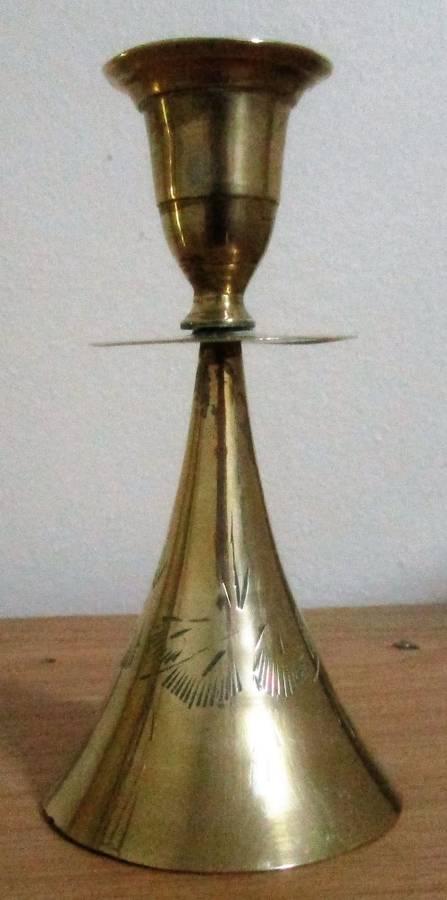 A MARVELOUS BRASS CANLE HOLDER ON TOP AND BELL ON THE BOTTOM SIDE
