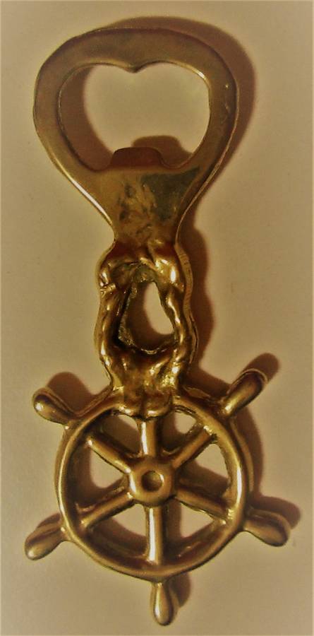 A STUNNING SHIP WHEEL DECORATED BRASS BOTTLE OPENER