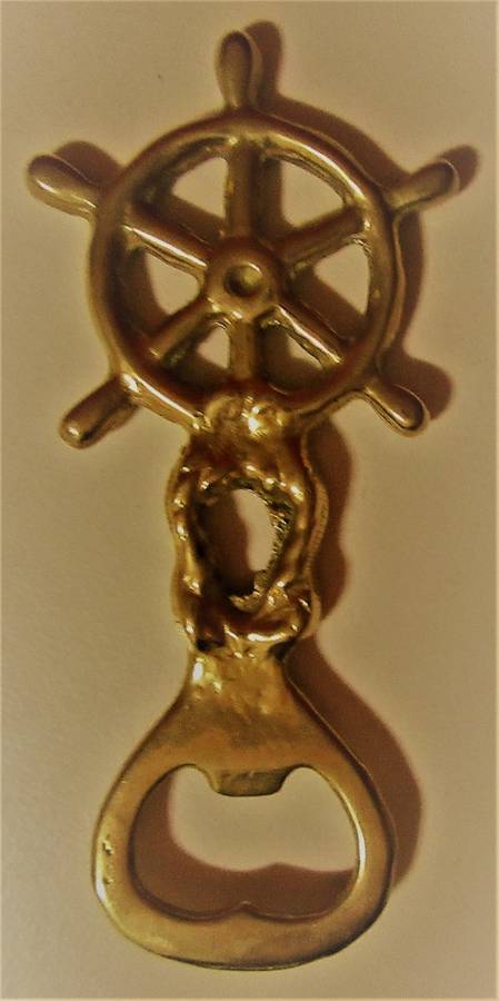 A STUNNING SHIP WHEEL DECORATED BRASS BOTTLE OPENER