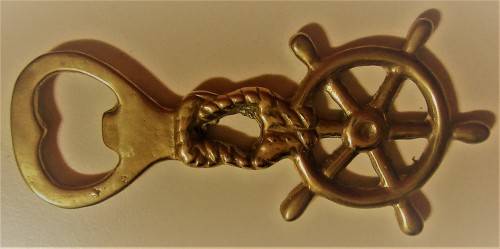 A STUNNING SHIP WHEEL DECORATED BRASS BOTTLE OPENER