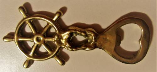 A STUNNING SHIP WHEEL DECORATED BRASS BOTTLE OPENER