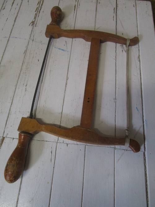 A lovely antique bow cut saw in wonderfully weathered condition with a great primitive look and feel