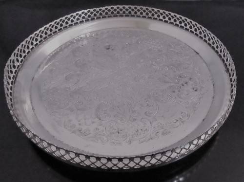 A Vintage Silver plated serving tray - Tray is round, has a pierced gallery edge and a ornate chased