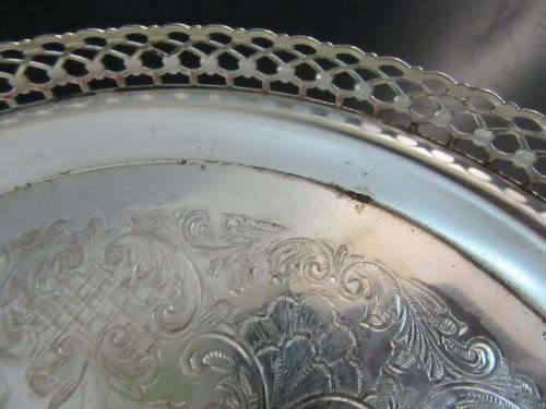 A Vintage Silver plated serving tray - Tray is round, has a pierced gallery edge and a ornate chased