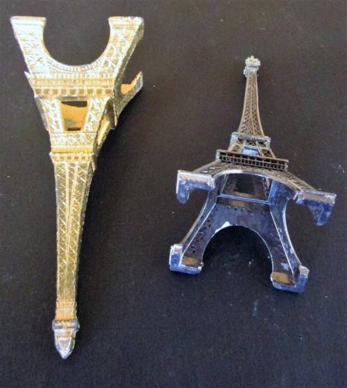 A nice pair of statues of the Eiffel Tower In Paris, originally made as visitor's souvenirs.  They l