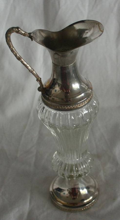 A SPECTACULAR CUT GLASS VINGAR DECANTER WITH SILVER METAL FINISH