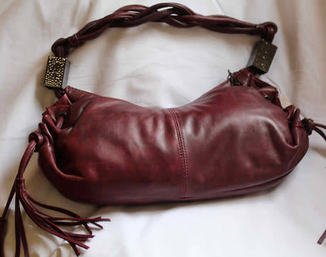 GENUINE JENNIFER LOPEZ (JLO) BURGUNDY ORIGINAL LEATHER 'HOBO' HANDBAG WITH TASSEL DETAILS.