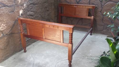 Really old, beautiful wooden double bed.