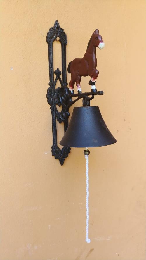 Awesome metal horse outside bell.