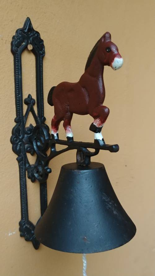Awesome metal horse outside bell.