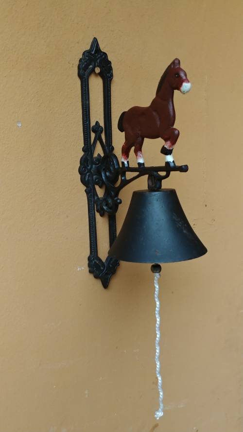 Awesome metal horse outside bell.