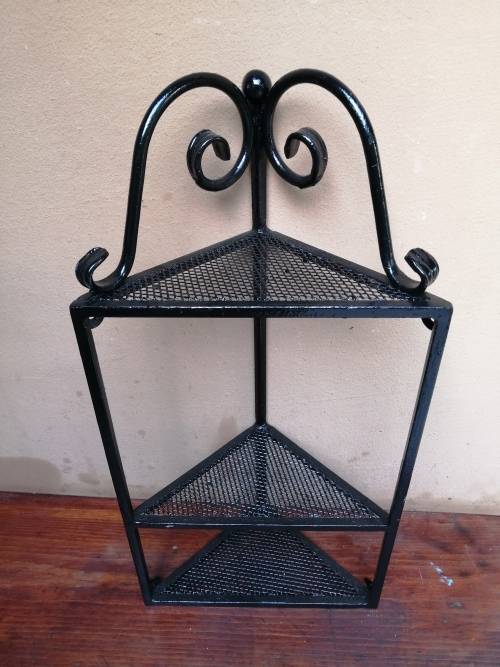 Beautiful metal wall mounted corner shelf.