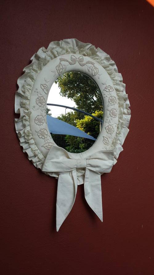 Beautiful oval, padded mirror.