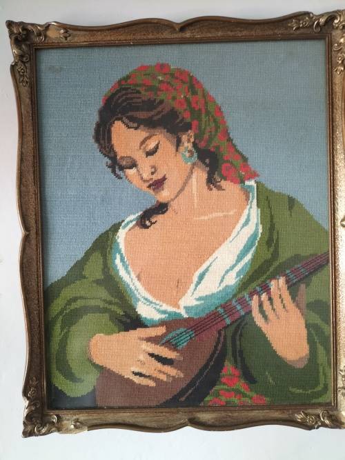 Framed Tapestry of Girl playing an Instrument.