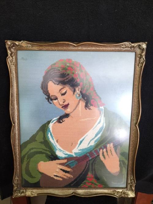 Framed Tapestry of Girl playing an Instrument.