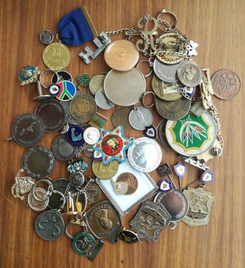 Large collection of medals, pins, tokens and costume jewelry.