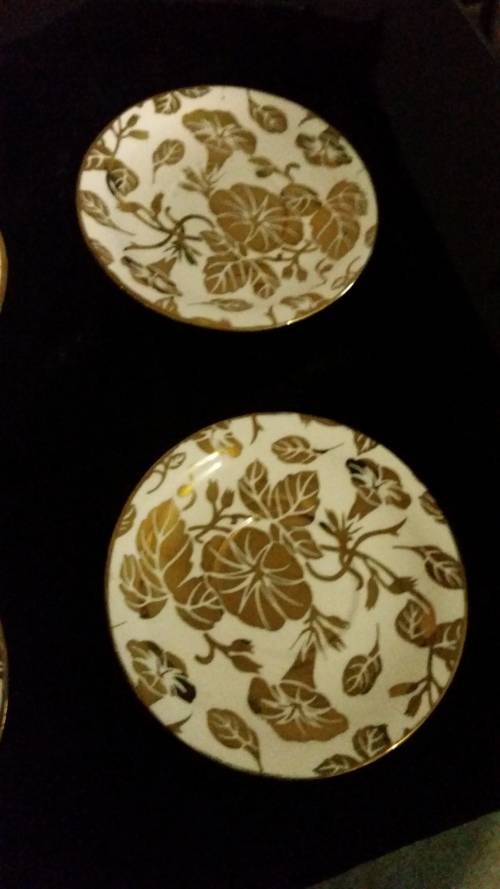 A pair of golden leaf plates