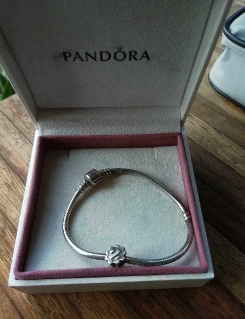 PANDORA SILVER BRACELET WITH SILVER CHARM.