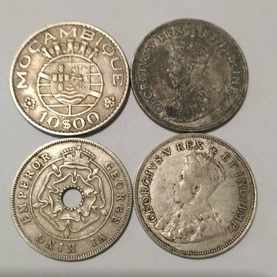 FOUR COINS, EAST AFRICA, 1922 ONE SHILLING, AND MACAMBIQUE AND SOUTH RHODESIA.