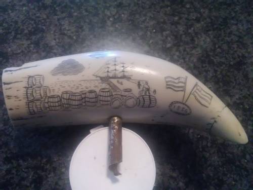 Unique Whale tooth inscribed with pictures depicting whaling activities and a ship.