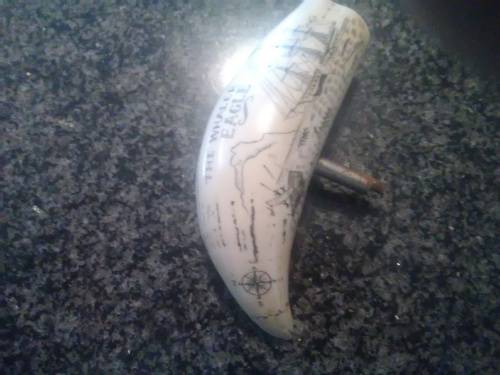 Unique Whale tooth inscribed with pictures depicting whaling activities and a ship.
