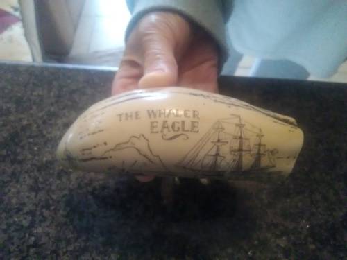 Unique Whale tooth inscribed with pictures depicting whaling activities and a ship.