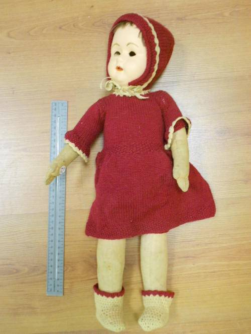 Composition doll with red coat, eyes are missing - as per scan