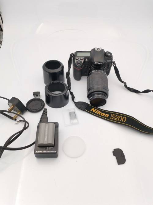 NIKON D200 CAMERA WORKING COMPLETE WITH CHARGER AND LENSE PLEASE NOTE THE BATTERY COVER IS LOSE!!!