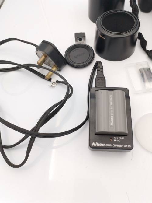 NIKON D200 CAMERA WORKING COMPLETE WITH CHARGER AND LENSE PLEASE NOTE THE BATTERY COVER IS LOSE!!!
