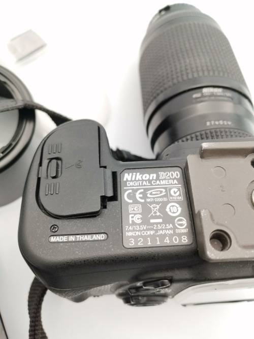 NIKON D200 CAMERA WORKING COMPLETE WITH CHARGER AND LENSE PLEASE NOTE THE BATTERY COVER IS LOSE!!!