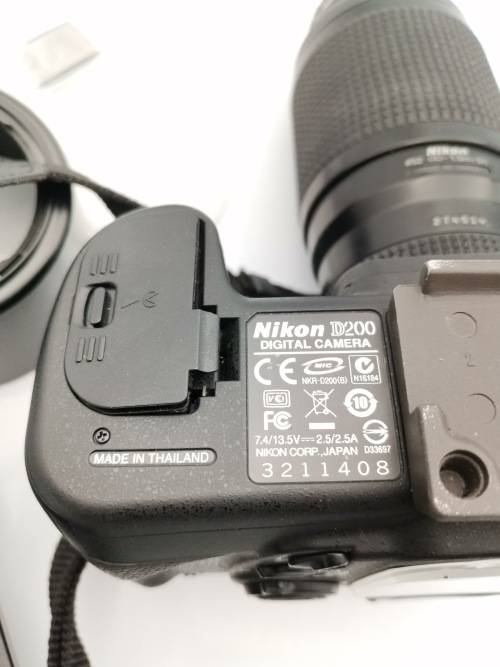 NIKON D200 CAMERA WORKING COMPLETE WITH CHARGER AND LENSE PLEASE NOTE THE BATTERY COVER IS LOSE!!!