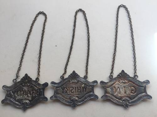 VINTAGE WHISKY, BRANDY and GIN DECANTER , ENAMELED BRASS NECK TAGS