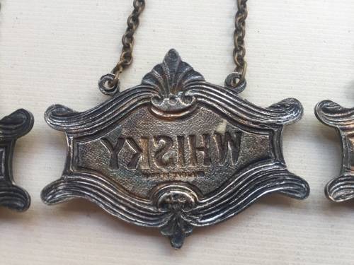 VINTAGE WHISKY, BRANDY and GIN DECANTER , ENAMELED BRASS NECK TAGS