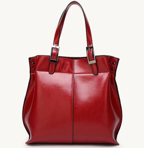 Beautiful elegant Tote style ladies handbag, with strap. Maroon color. Stock in South Africa