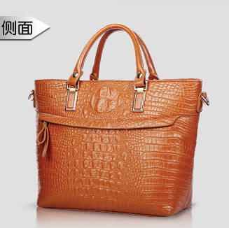 Elegant crocodile pattern ladies handbag with strape, brown color. Stock in ZA
