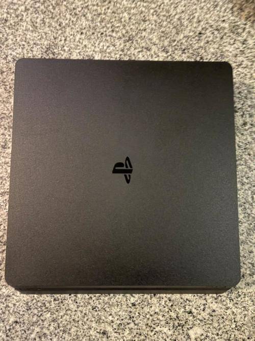 PLAYSTATION SLIM 1 TB WITH 2 CONTROLLERS and 1 GAME