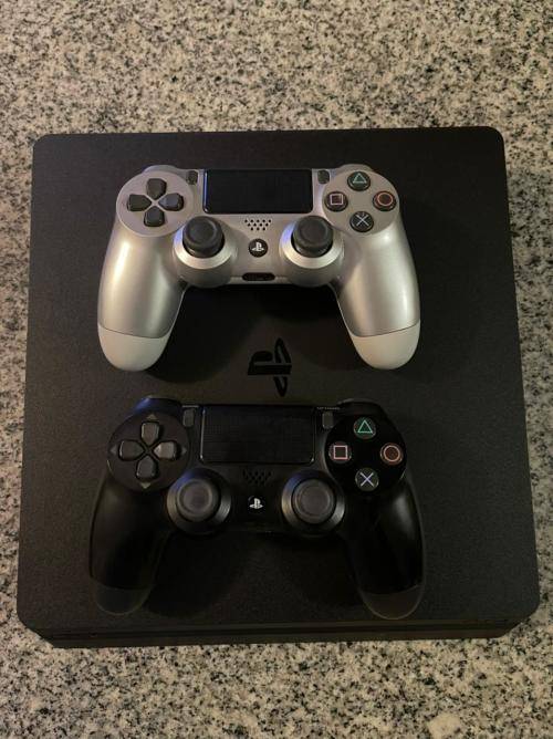 PLAYSTATION SLIM 1 TB WITH 2 CONTROLLERS and 1 GAME