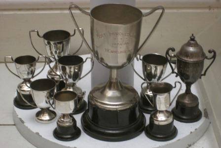 8 small and 1 med size vintage silver plated trophies